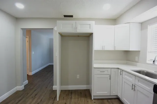 a kitchen with a sink and cabinets