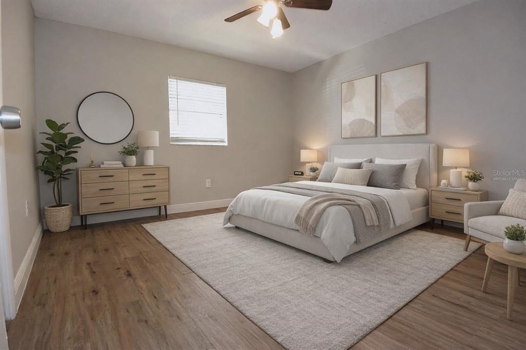 5845 Elm Street New Port Richey, FL 34652 - Photo 13 of 38 a bedroom with a bed cupboard mirror and window