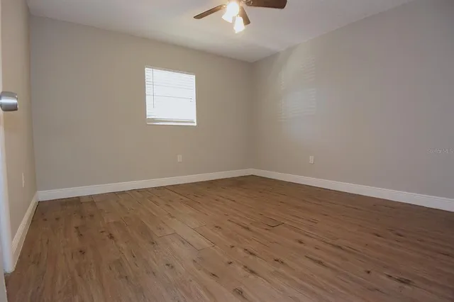 wooden floor in an empty room with a window