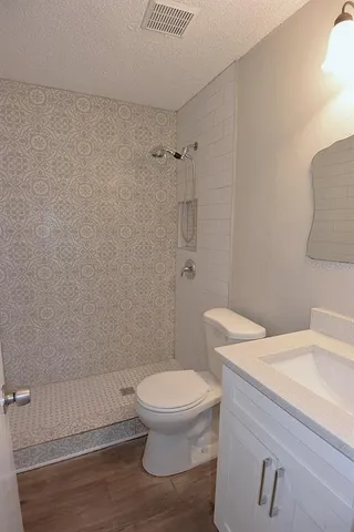 a bathroom with a toilet and a shower