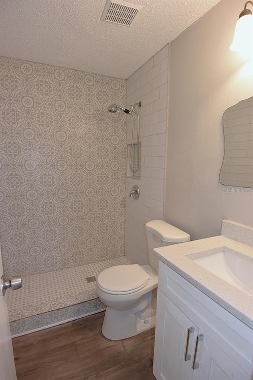 5845 Elm Street New Port Richey, FL 34652 - Photo 16 of 38 a bathroom with a toilet and a shower