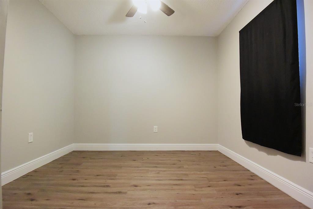 5845 Elm Street New Port Richey, FL 34652 - Photo 19 of 38 a view of an empty room with wooden floor