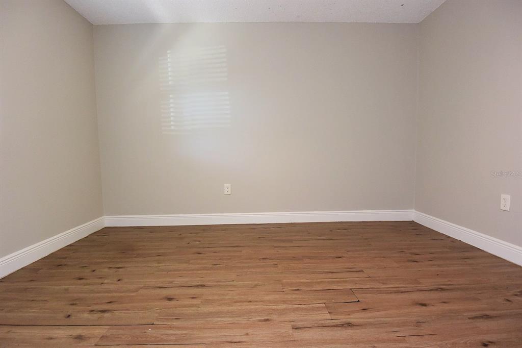 5845 Elm Street New Port Richey, FL 34652 - Photo 20 of 38 a view of an empty room and wooden floor