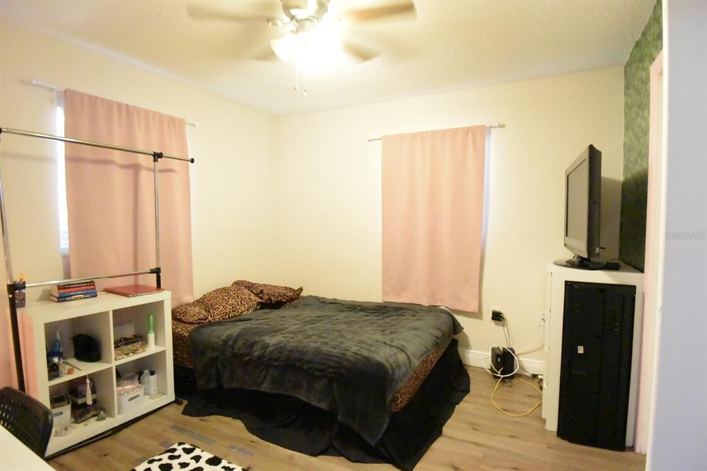 5845 Elm Street New Port Richey, FL 34652 - Photo 27 of 38 a bedroom with a bed a fireplace and a walk in closet