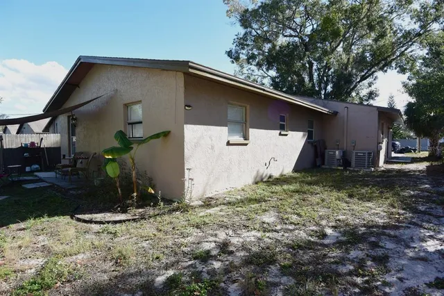 a view of a house with backyard and trees