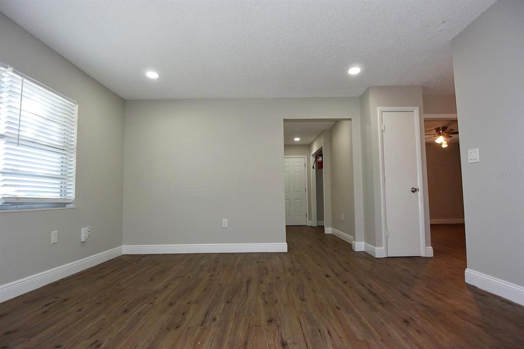 5845 Elm Street New Port Richey, FL 34652 - Photo 6 of 38 an empty room with wooden floor and windows