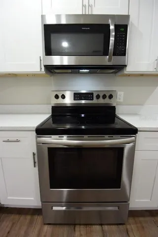 a stove top oven sitting inside of a kitchen