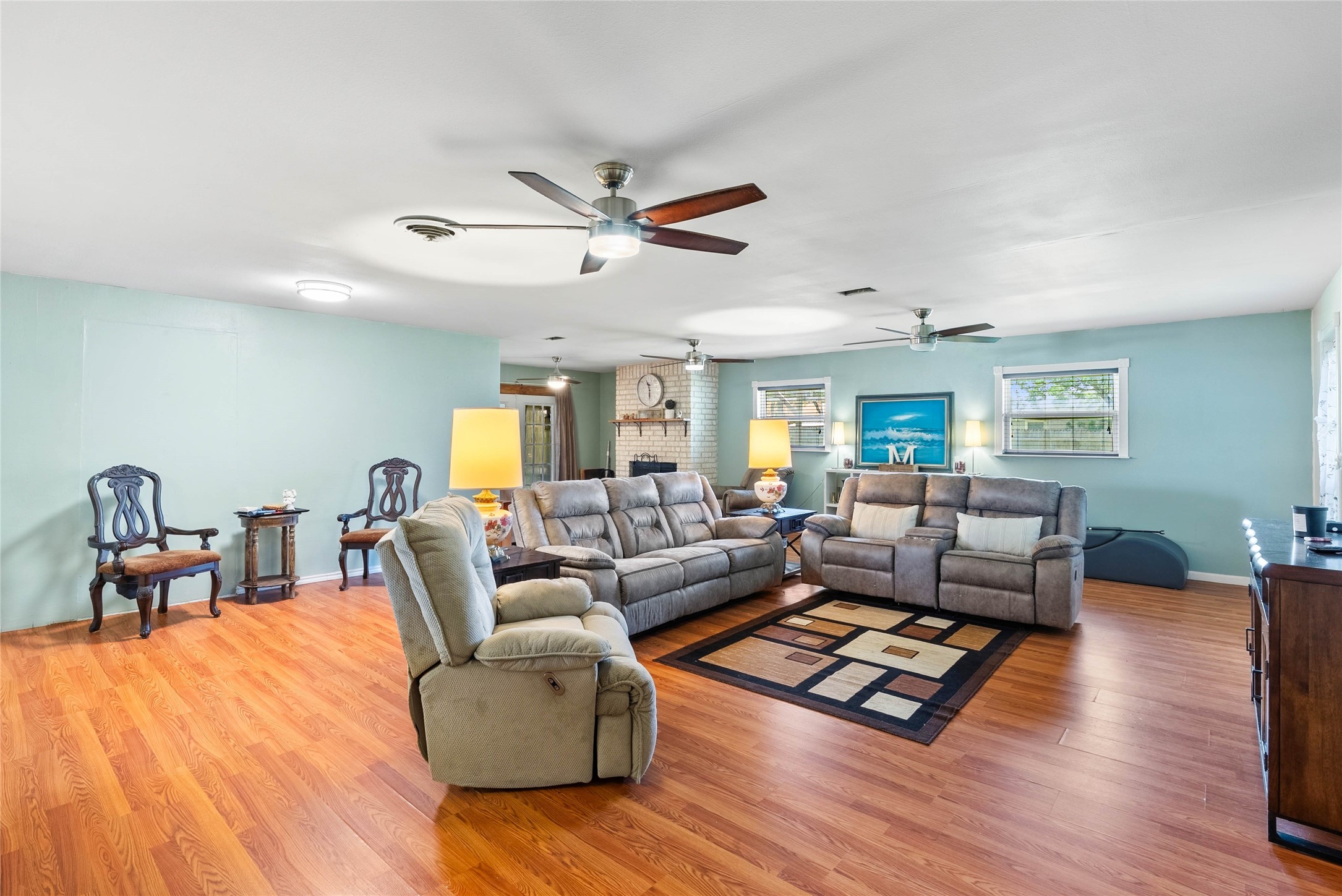 168 Sunset Ingleside, TX 78362 - Photo 4 of 26 Expansive main living room boasting beautiful hardwood-style flooring, a ceiling fan, and a highly spacious layout.