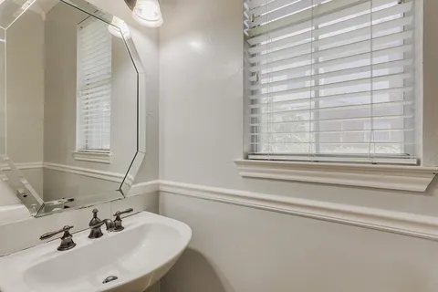 a bathroom with a sink and a window