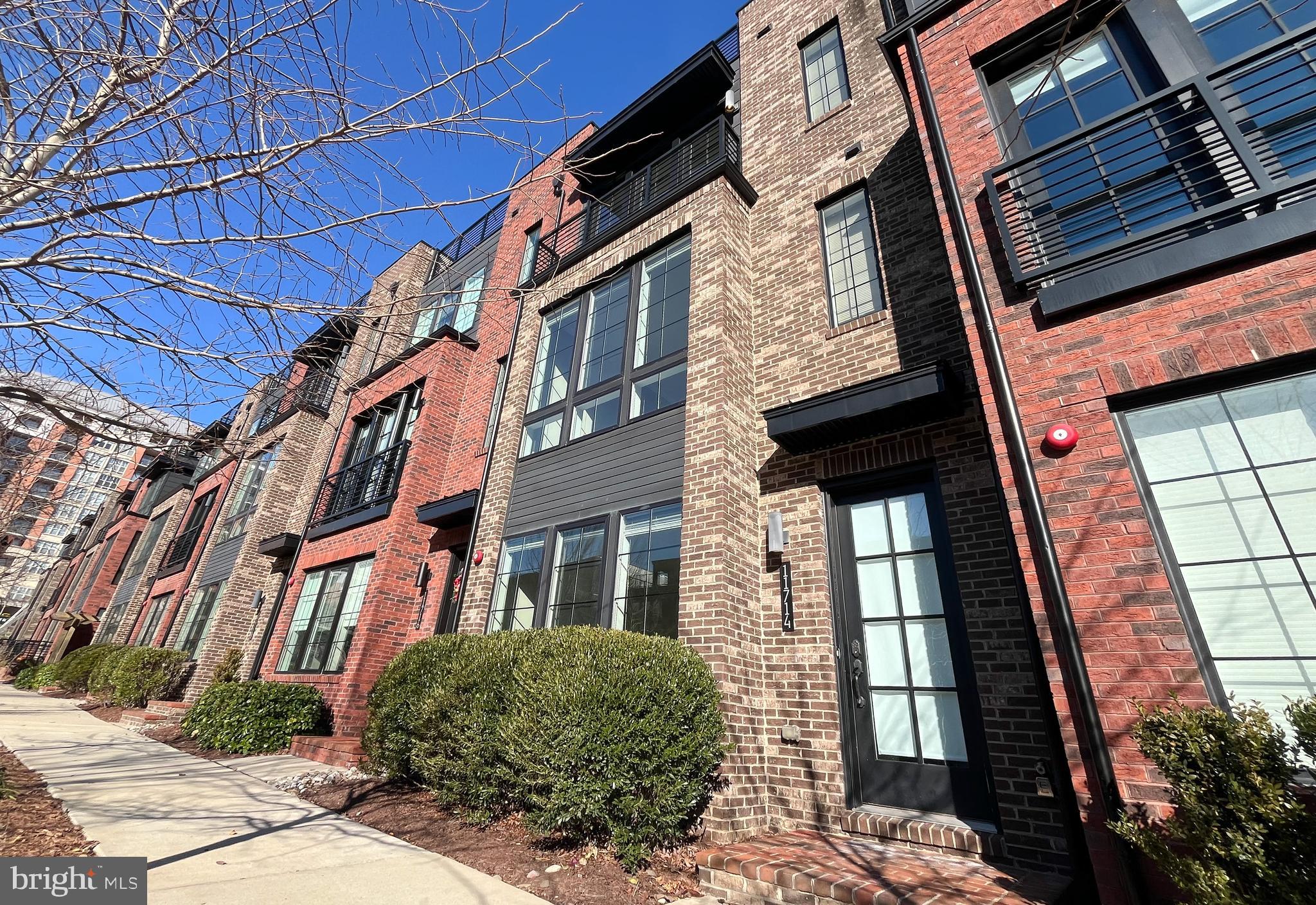11714 Paysons Way Reston, VA 20191 - Photo 2 of 33 a view of a brick building next to a yard