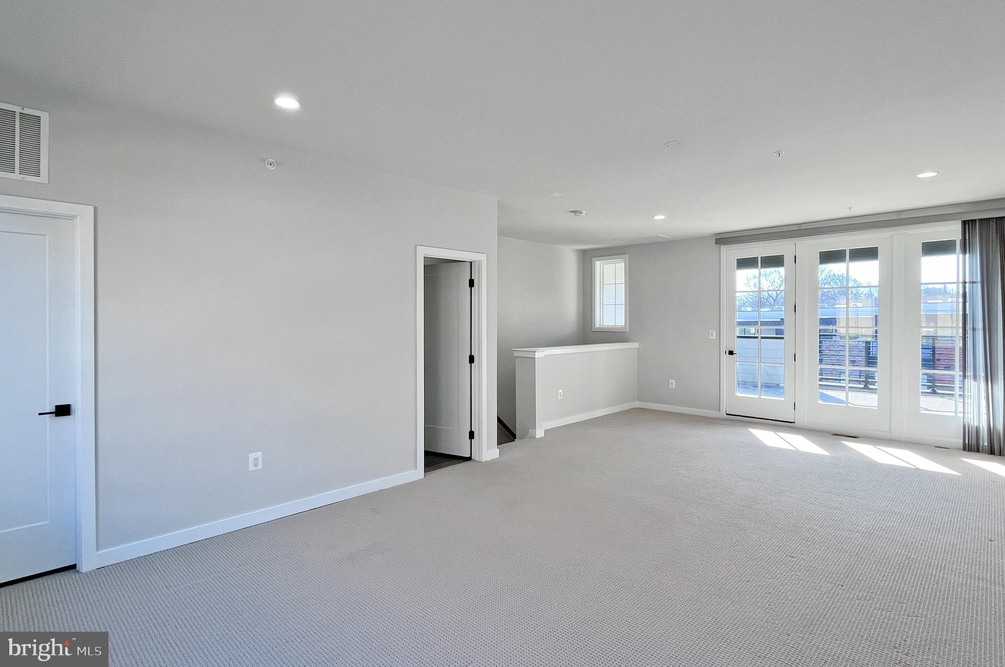 11714 Paysons Way Reston, VA 20191 - Photo 24 of 33 a view of an empty room with a window and a kitchen