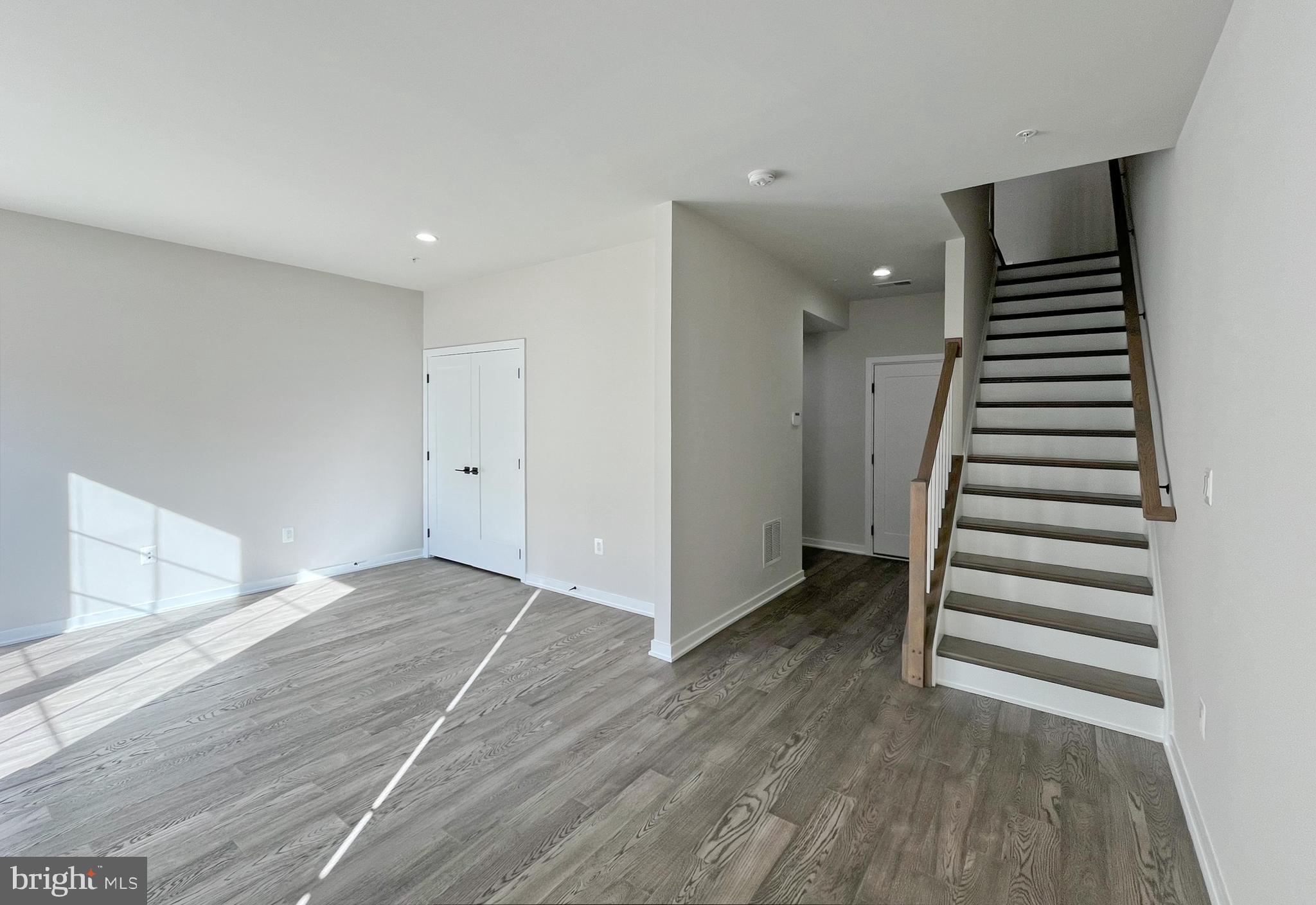 11714 Paysons Way Reston, VA 20191 - Photo 27 of 33 wooden floor in an empty room with stairs