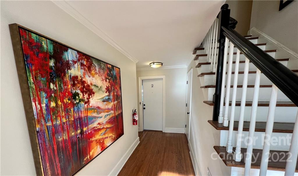1708 Dilworth Road West, Unit 2 Charlotte, NC 28203 - Photo 2 of 8 a view of a hallway with wooden floor and staircase