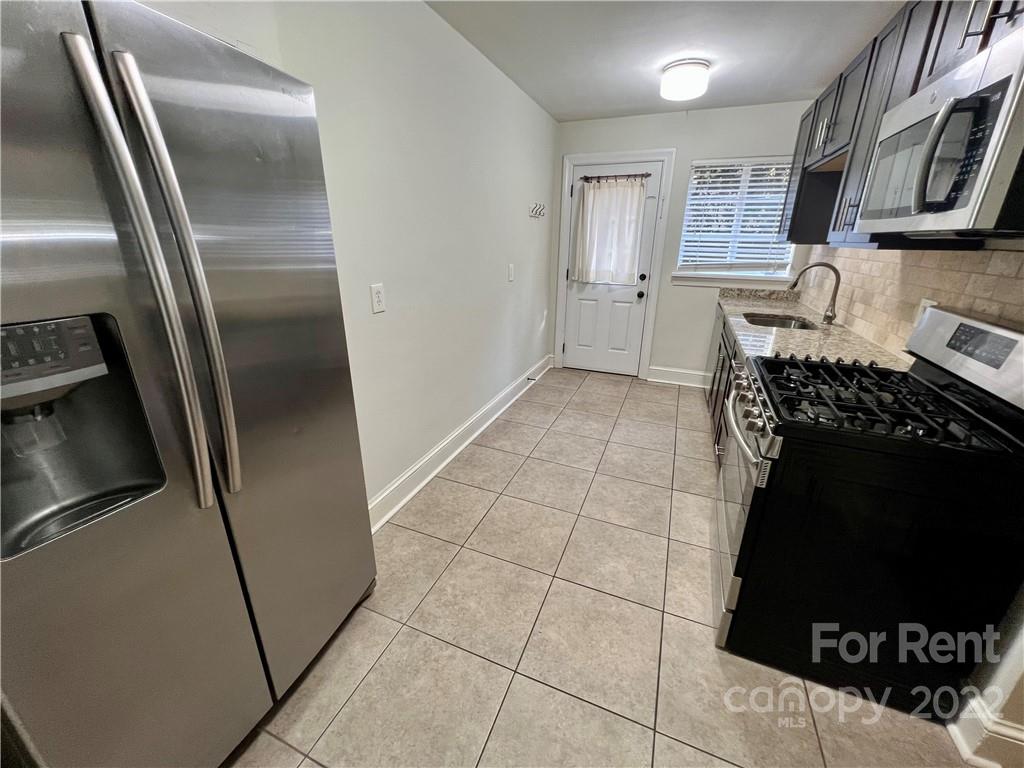 1708 Dilworth Road West, Unit 2 Charlotte, NC 28203 - Photo 4 of 8 a kitchen with granite countertop a refrigerator and a stove