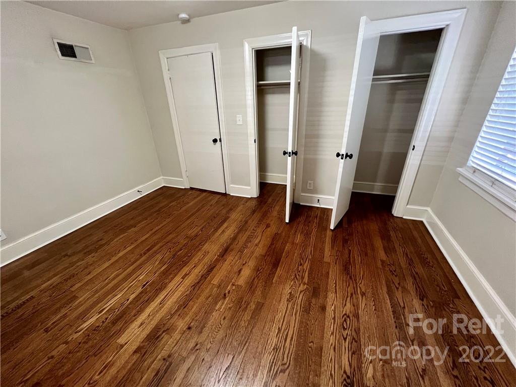 1708 Dilworth Road West, Unit 2 Charlotte, NC 28203 - Photo 7 of 8 an empty room with wooden floor and a ceiling fan
