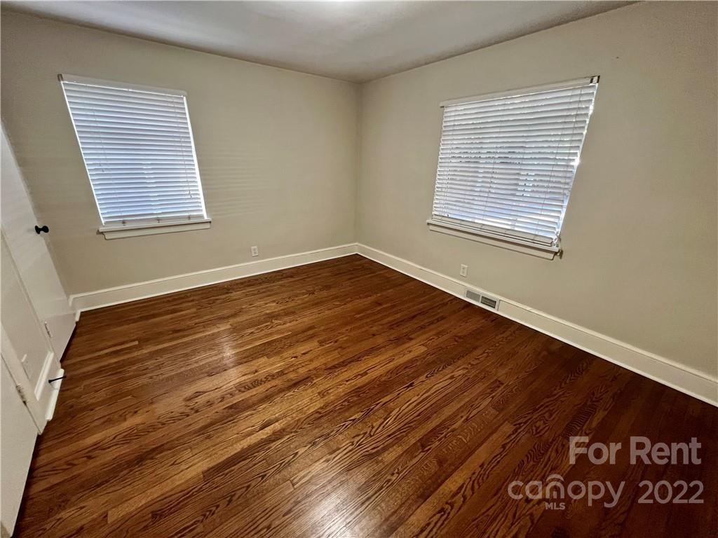 1708 Dilworth Road West, Unit 2 Charlotte, NC 28203 - Photo 8 of 8 a view of an empty room with wooden floor and a window