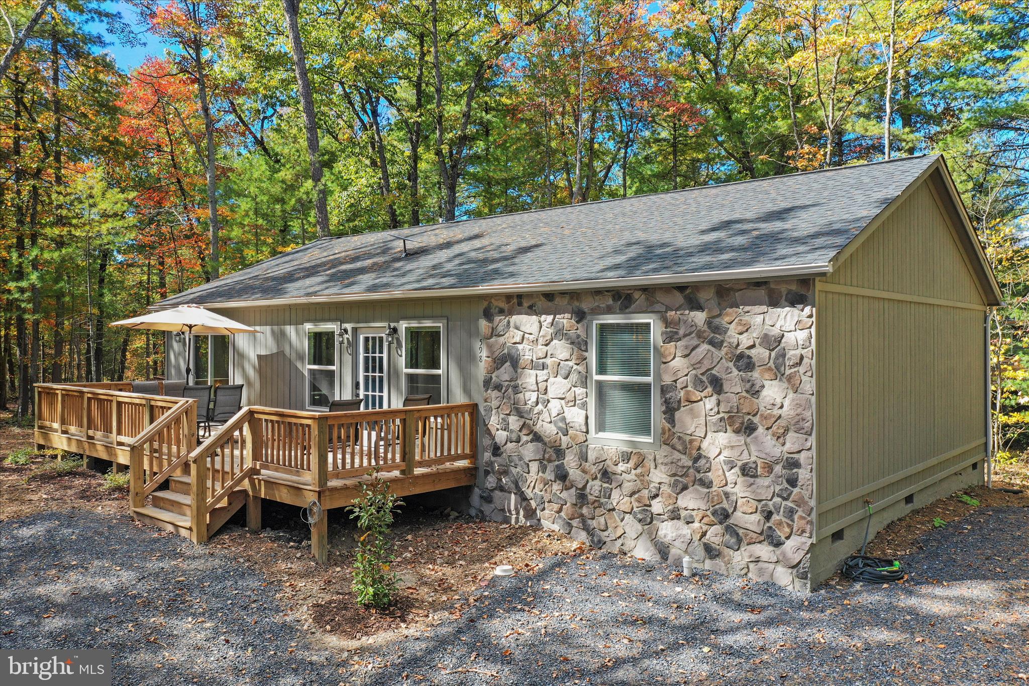 598 Crabapple Road Mount Jackson, VA 22842 - Photo 1 of 32 a backyard of a house with barbeque oven table and chairs