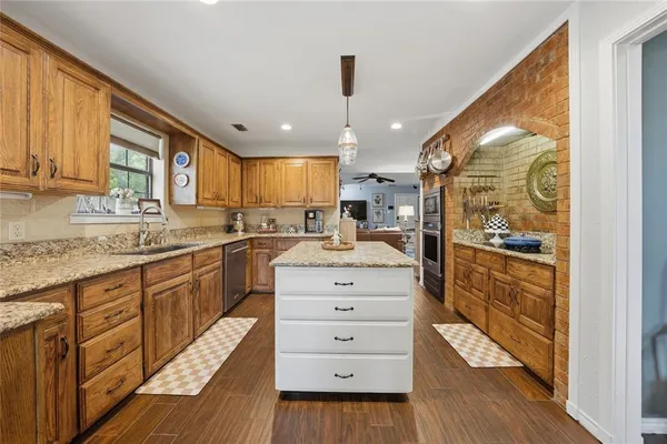 a kitchen with sink and refrigerator