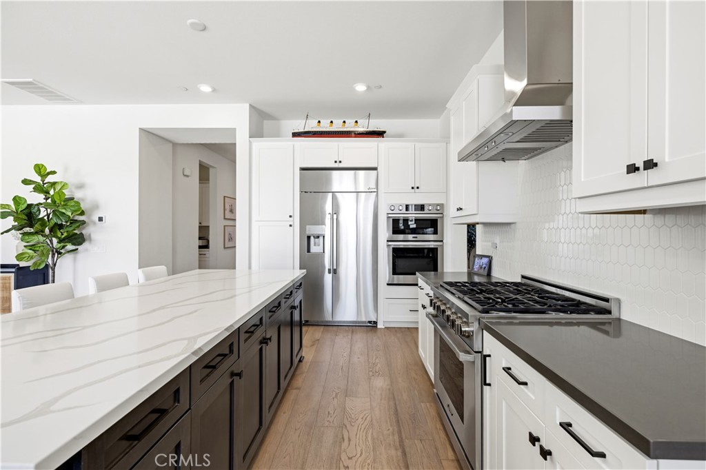 28346 Old Spgs Road Castaic, CA 91384 - Photo 14 of 69 a kitchen with kitchen island stainless steel appliances a sink stove and refrigerator