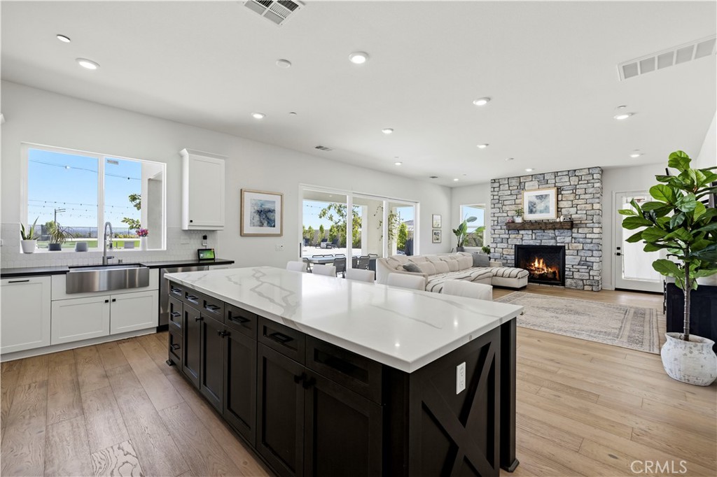28346 Old Spgs Road Castaic, CA 91384 - Photo 15 of 69 a kitchen with sink island and wooden floor