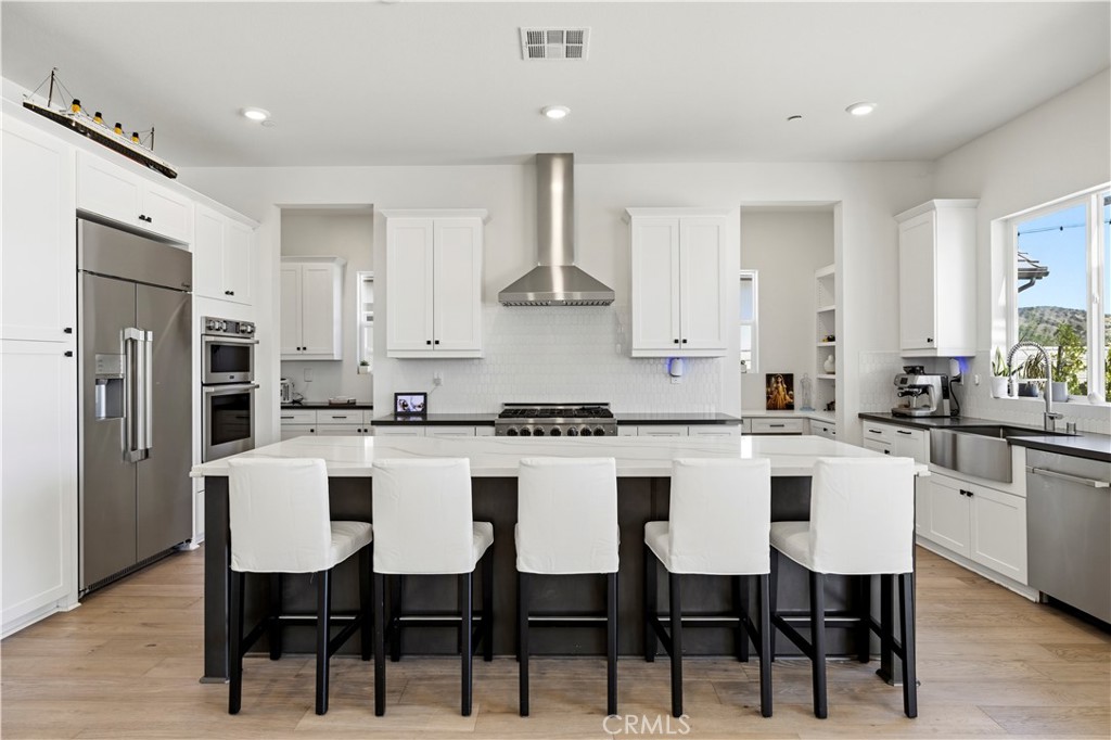 28346 Old Spgs Road Castaic, CA 91384 - Photo 18 of 80 a kitchen with stainless steel appliances granite countertop a table chairs stove microwave and cabinets