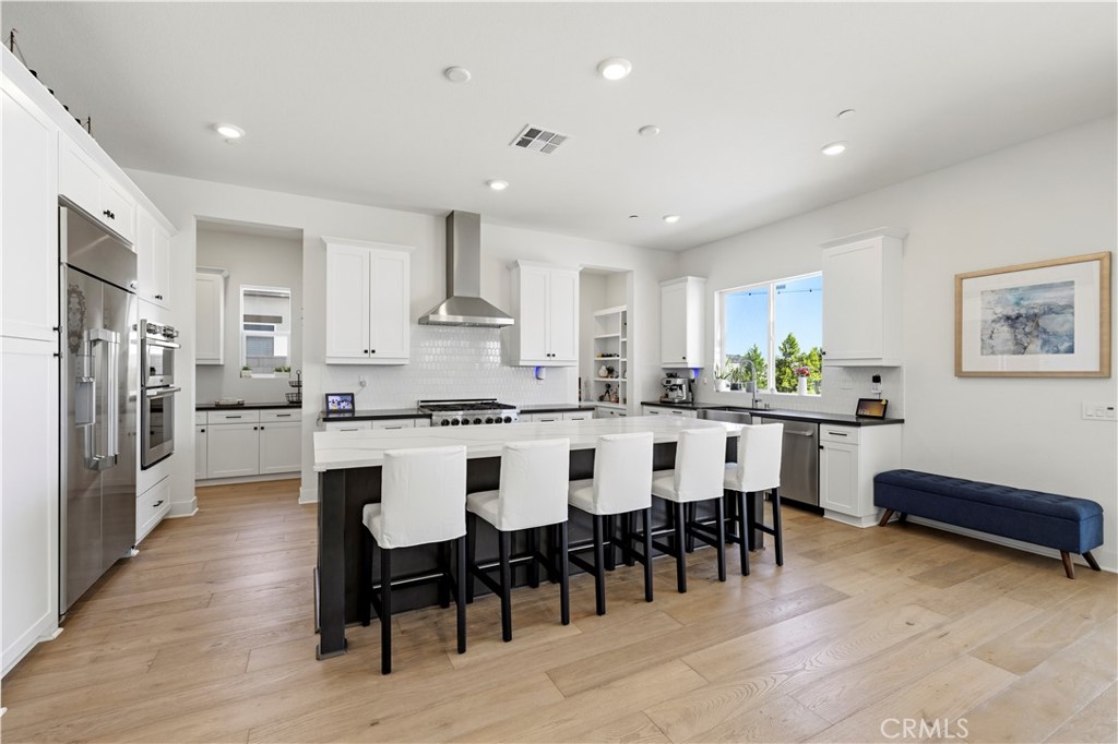28346 Old Spgs Road Castaic, CA 91384 - Photo 19 of 80 a kitchen with stainless steel appliances a dining table chairs refrigerator and sink