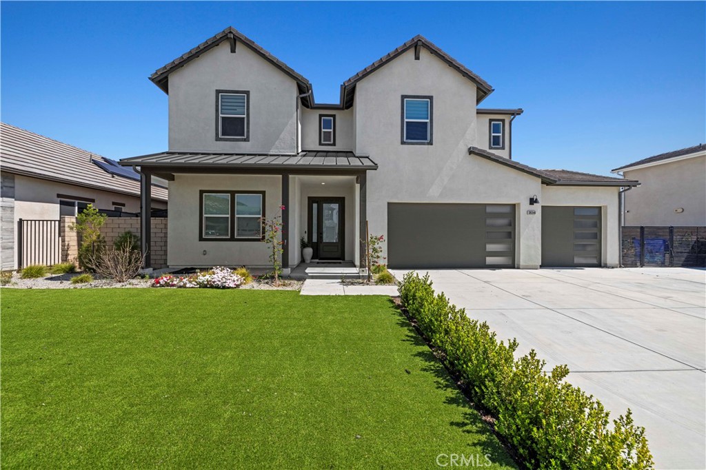 28346 Old Spgs Road Castaic, CA 91384 - Photo 3 of 69 a view of a white house with a big yard and potted plants