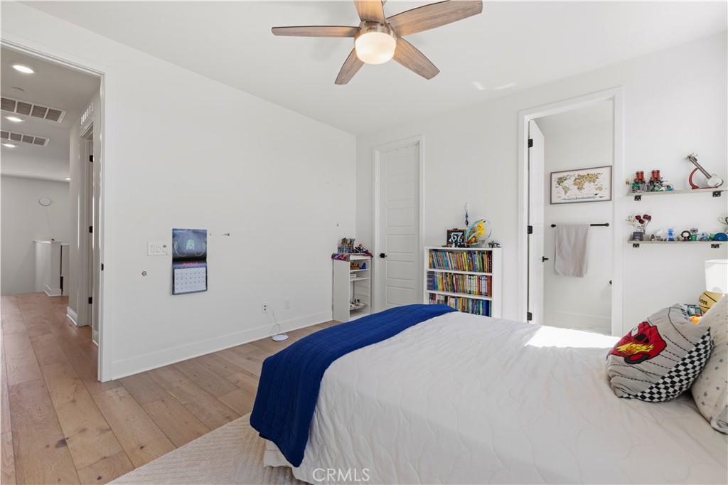 28346 Old Spgs Road Castaic, CA 91384 - Photo 34 of 69 a bedroom with a bed and a chandelier