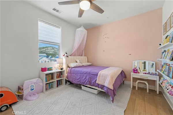 a bathroom with a granite countertop sink toilet and mirror