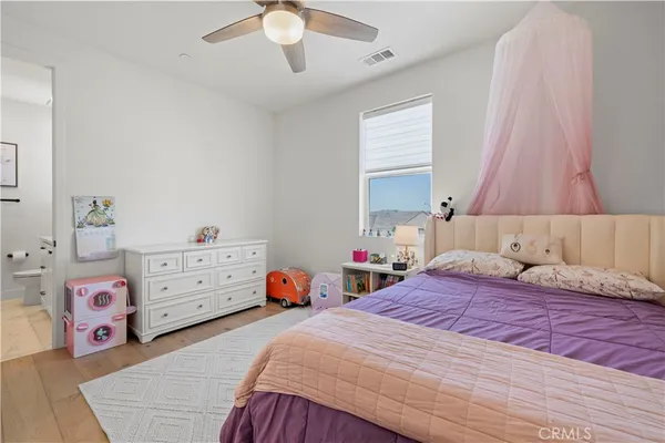 a view of swimming pool with red chairs under an umbrella