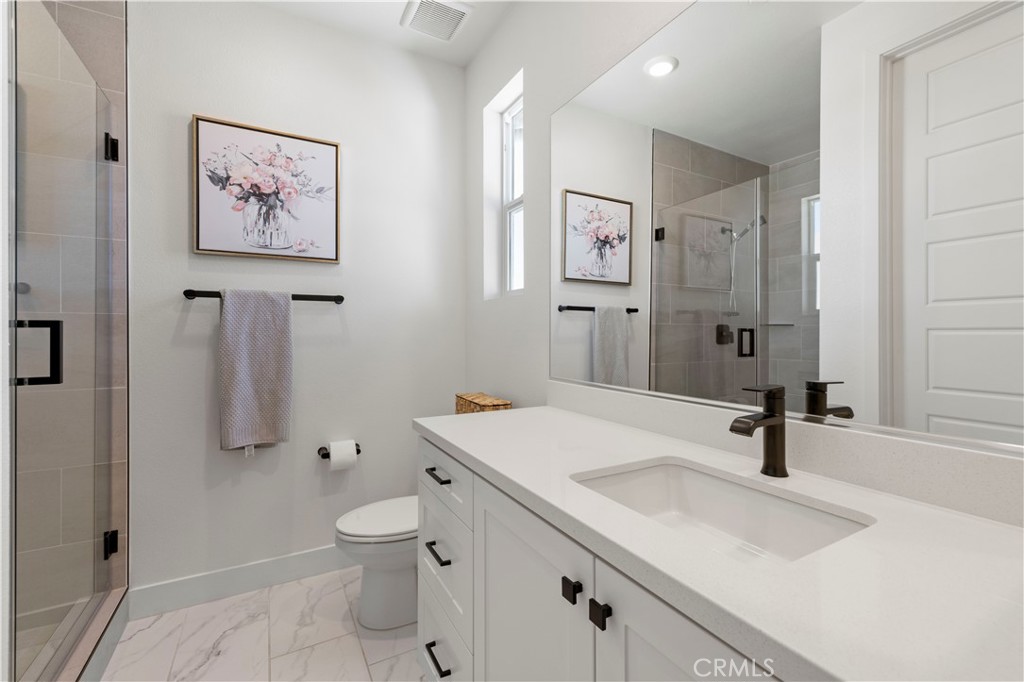 28346 Old Spgs Road Castaic, CA 91384 - Photo 38 of 69 a bathroom with a sink a toilet and a mirror
