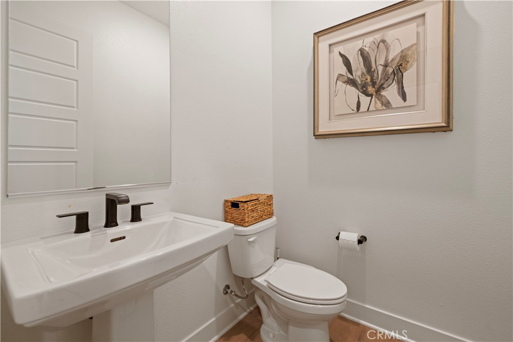 28346 Old Spgs Road Castaic, CA 91384 - Photo 44 of 69 a white toilet sitting next to a bathroom sink