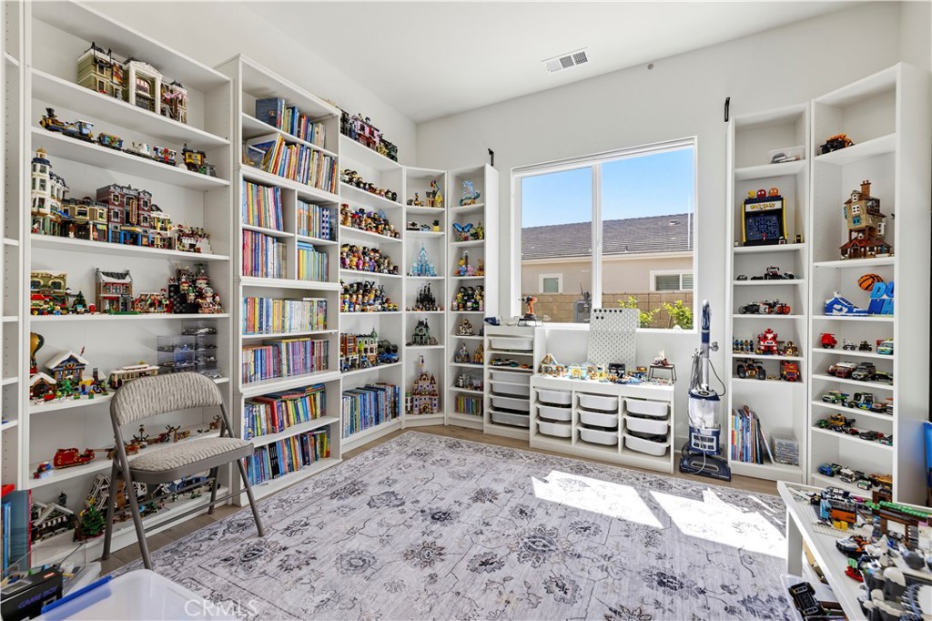 28346 Old Spgs Road Castaic, CA 91384 - Photo 44 of 80 a room with furniture a bookshelf and a window