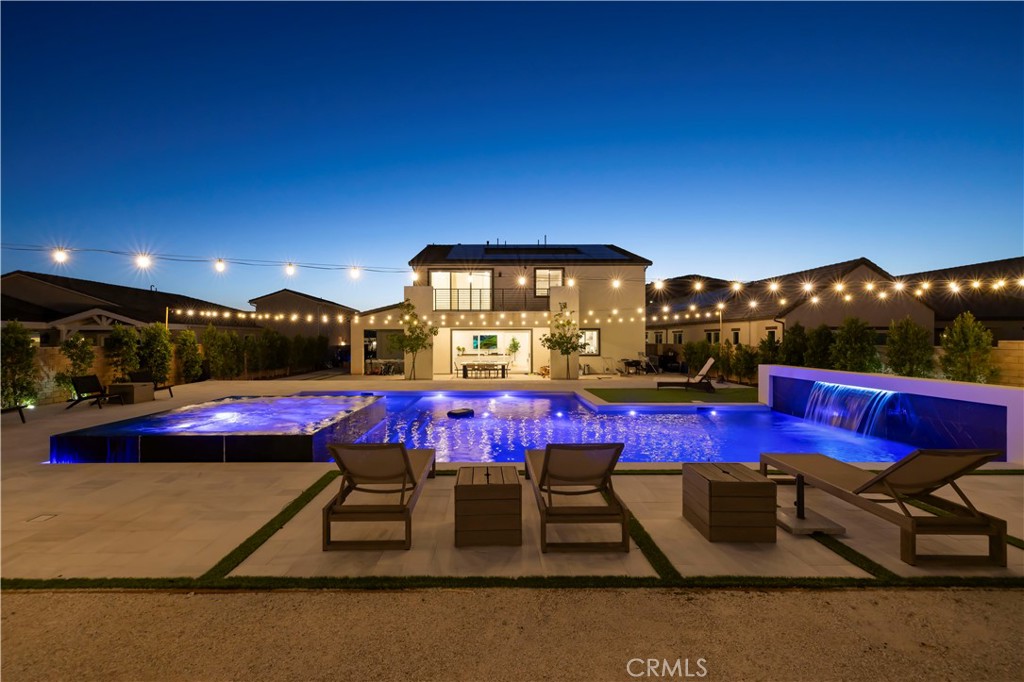 28346 Old Spgs Road Castaic, CA 91384 - Photo 46 of 69 a view of swimming pool with red chairs under an umbrella