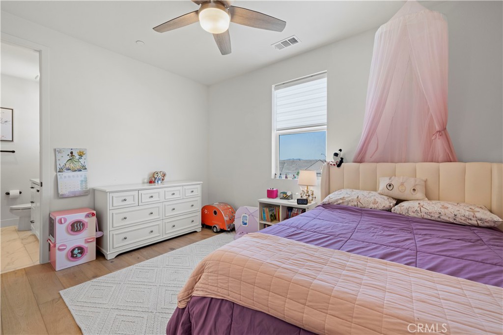 28346 Old Spgs Road Castaic, CA 91384 - Photo 49 of 80 a bedroom with a bed and a chandelier