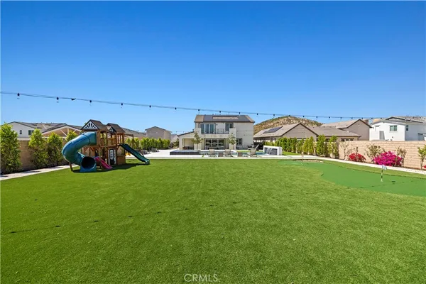 a view of a play ground in front of a house