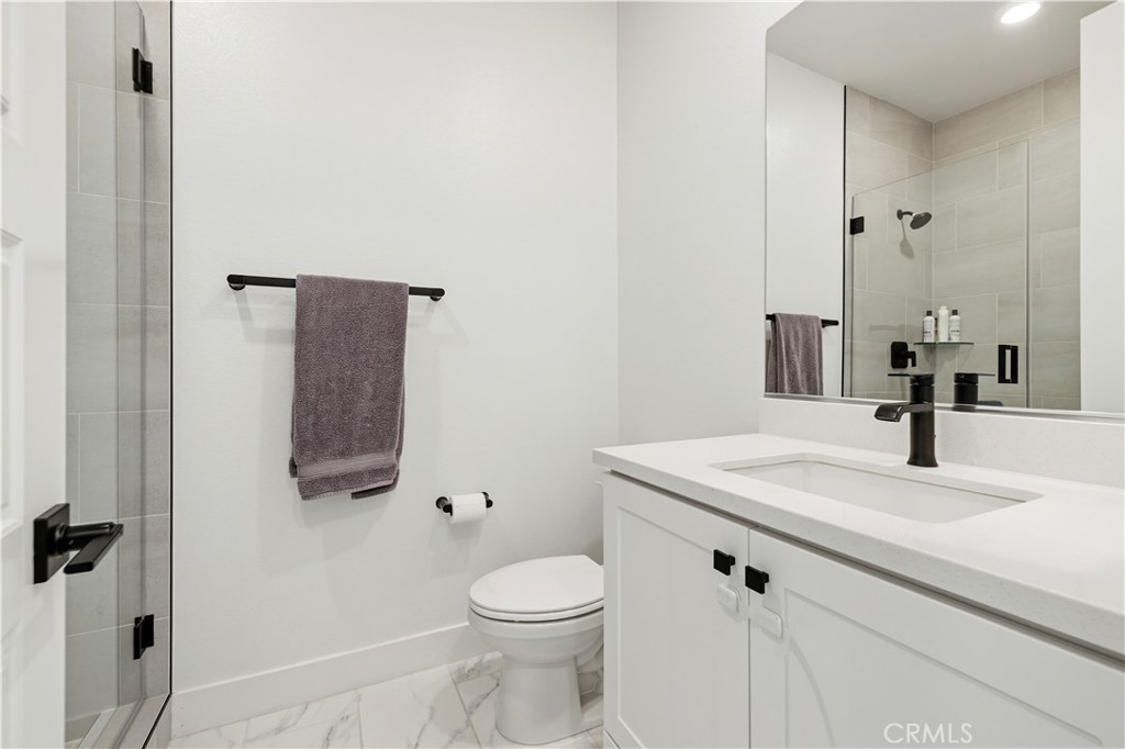28346 Old Spgs Road Castaic, CA 91384 - Photo 51 of 80 a bathroom with a granite countertop sink toilet and mirror