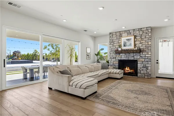 a kitchen with stainless steel appliances granite countertop a table chairs stove microwave and cabinets