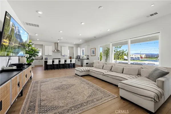 a kitchen with kitchen island a counter top space a sink stainless steel appliances and cabinets