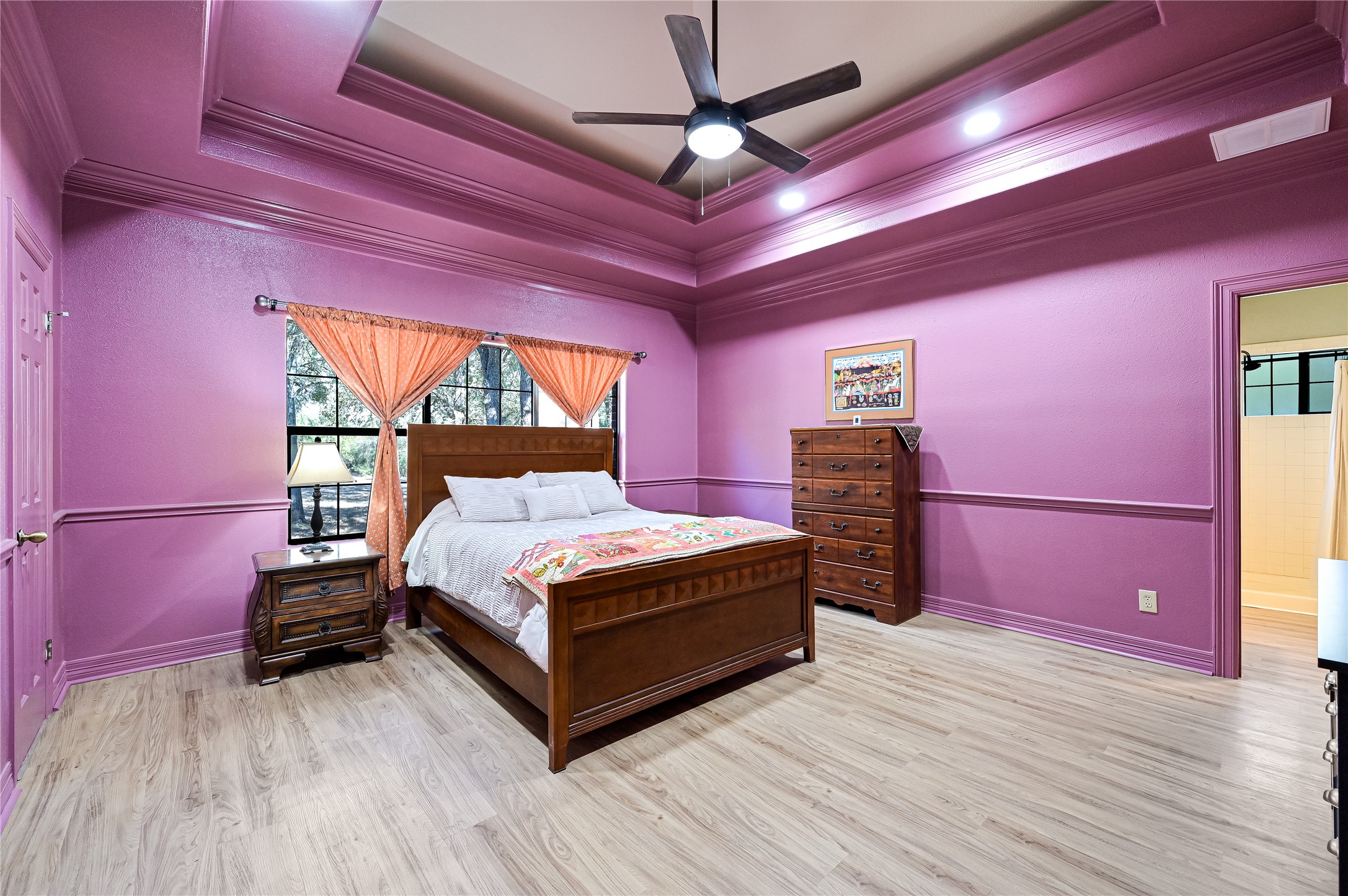 486 Westwood Road Lockhart, TX 78644 - Photo 14 of 29 Bedroom featuring a raised ceiling, crown molding, light wood-type flooring, a ceiling fan, and recessed lighting and walk in closets