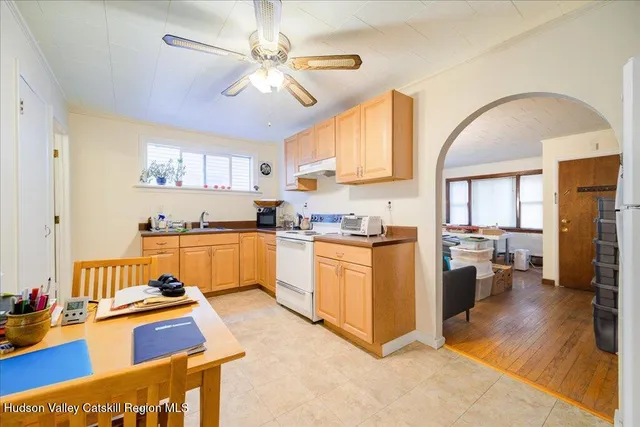 a kitchen with stainless steel appliances granite countertop a refrigerator a stove and a sink with dishwasher