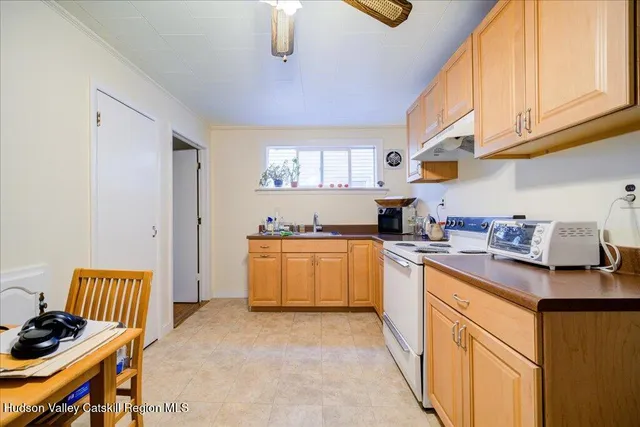 a kitchen with stainless steel appliances granite countertop a sink stove and cabinets