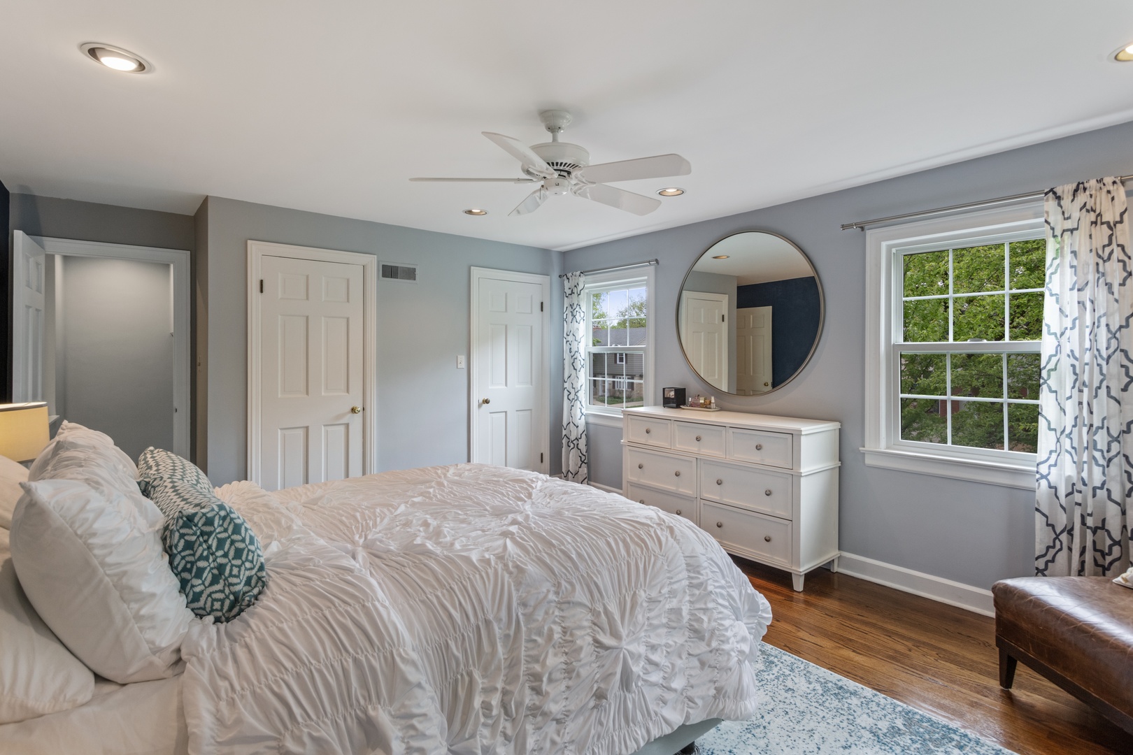 1152 Raleigh Road Glenview, IL 60025 - Photo 12 of 23 a bedroom with a bed a mirror on dresser and a window