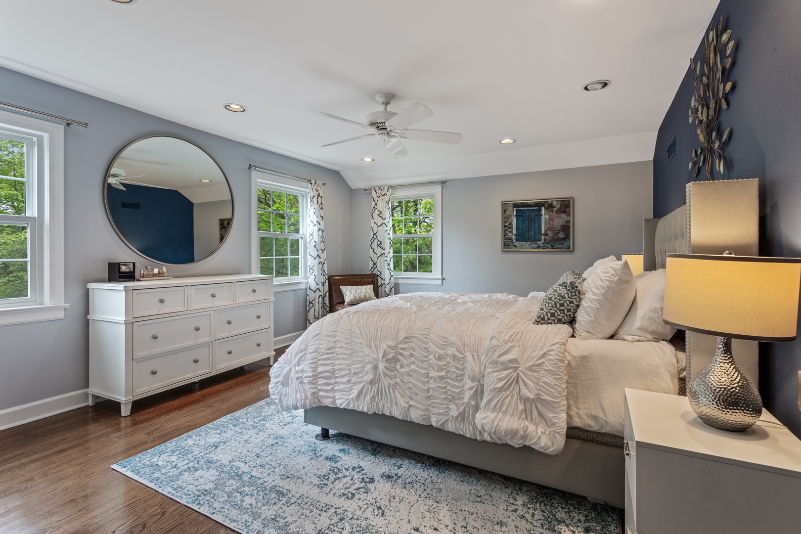 1152 Raleigh Road Glenview, IL 60025 - Photo 13 of 23 a bedroom with a bed a mirror on dresser and a window