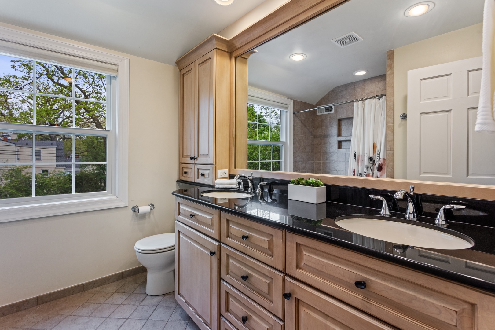 1152 Raleigh Road Glenview, IL 60025 - Photo 14 of 23 a bathroom with a granite countertop double vanity sink a mirror and a large window