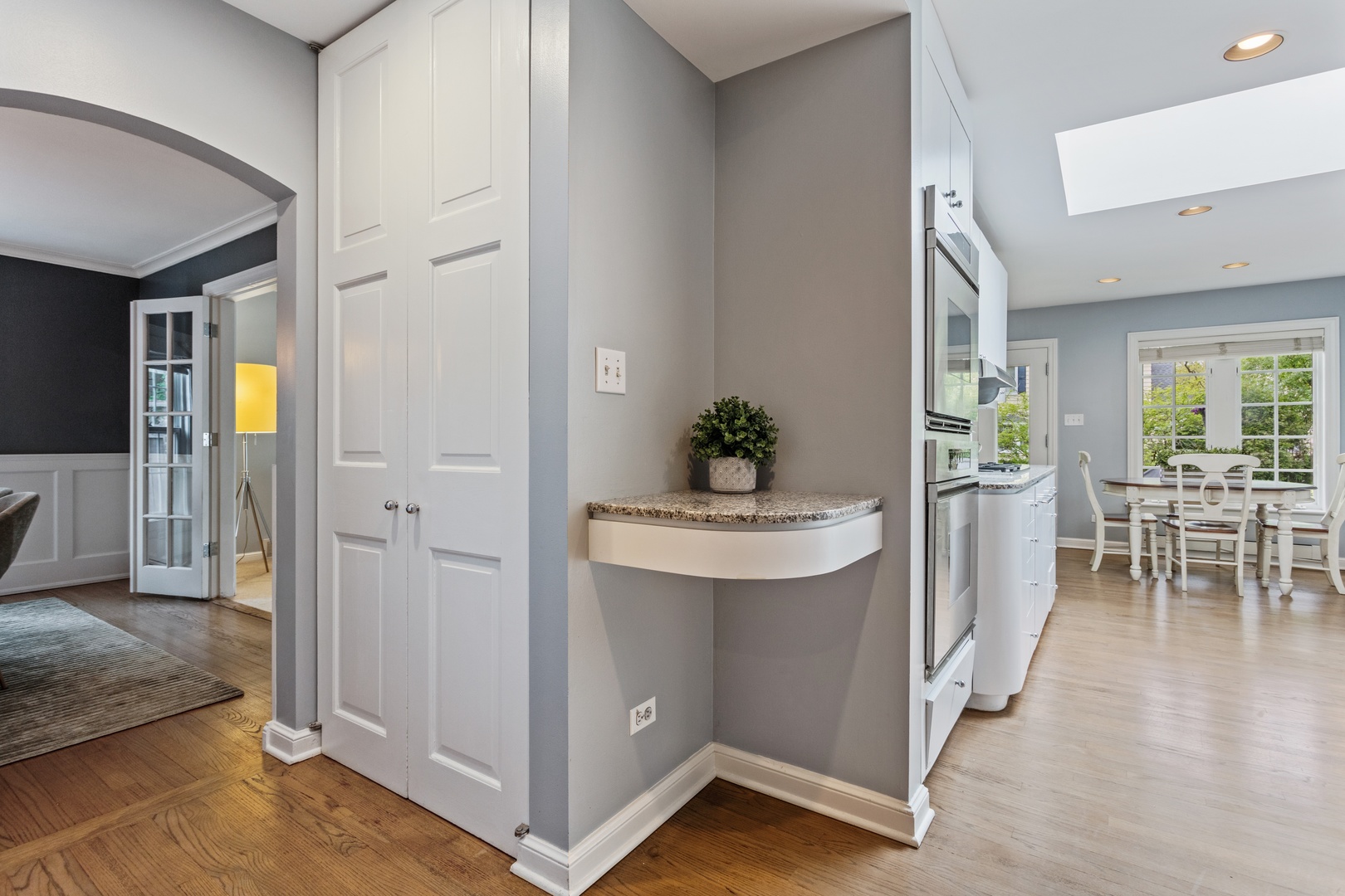 1152 Raleigh Road Glenview, IL 60025 - Photo 7 of 23 a view of a hallway with dining room and wooden floor