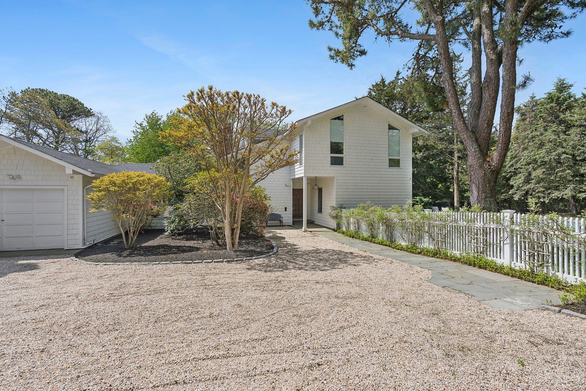 29 Petrel Road Southampton, NY 11968 - Photo 4 of 37 a white house that has tree in front of it