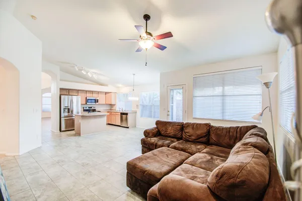 a living room with furniture and kitchen view
