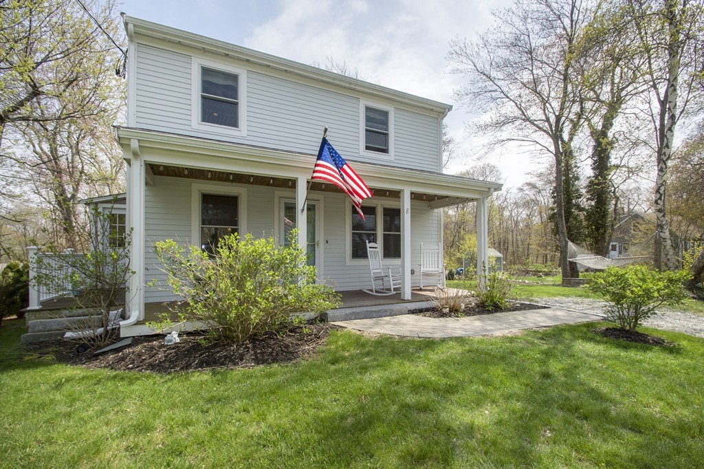 a view of a house with a yard and sitting area