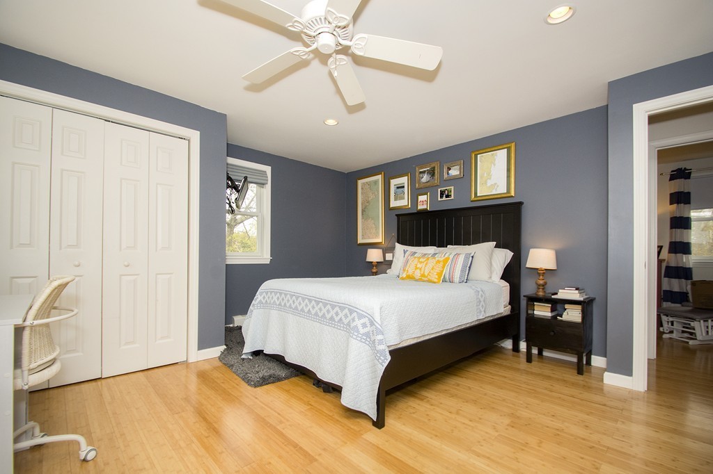 8 Seamore Road Scituate, MA 02066 - Photo 13 of 28 a bed room with a bed and a chandelier